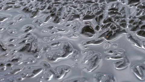 Water drop falling on melting ice Stock Footage 98045285