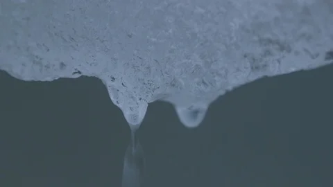 Water drop falling from melting piece of ice Stock Footage 104925971