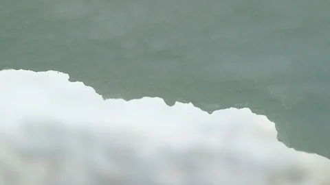 Water drop falling from melting piece of ice Video stock 104927162