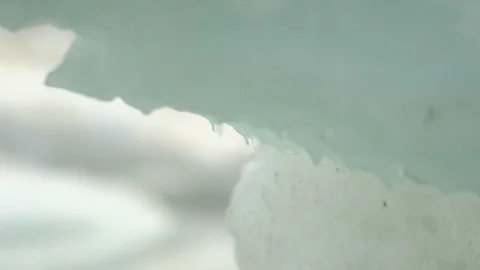 Water drop falling from melting piece of ice Stock Footage 104927283