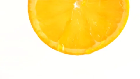 Water drop falling from orange on white background. Orange slice and water .. Stock Footage 274555099