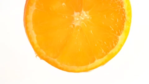 Water drop falling from orange on white background. Orange slice and water .. Stock Footage 281273122