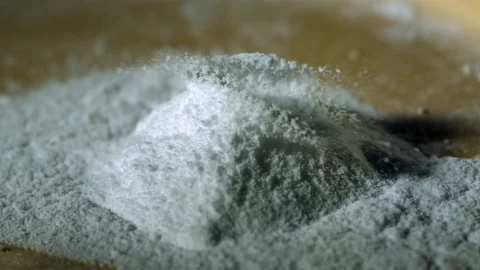 Water drop falling on a small heap of cocaine powder Stock Footage 81311382
