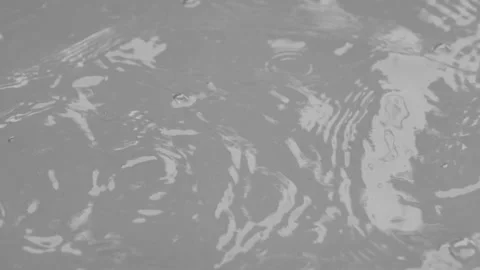 Water drop falling into water surface background Stock Footage 142677778