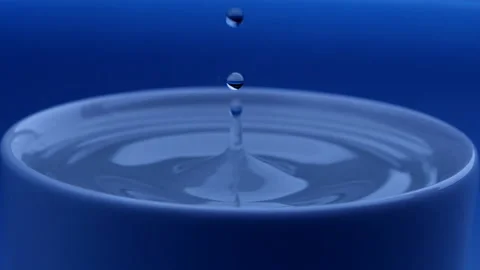 Water drop falls into the filled cup on blue background in slow motion. Stock Footage 142820669