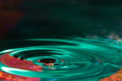 Water drop forms ripples Stock Photos