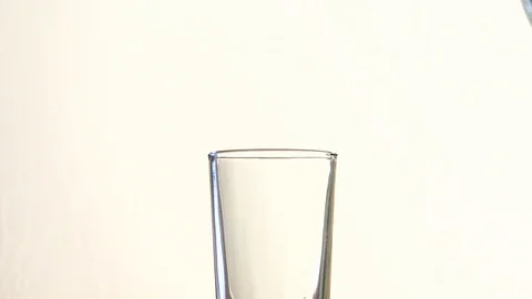 Water drop into a glass Stock Footage 113338128