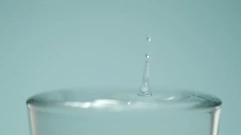 Water drop into glass 스톡 동영상 240134187