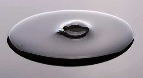 Water drop on grey surface Stock Photos
