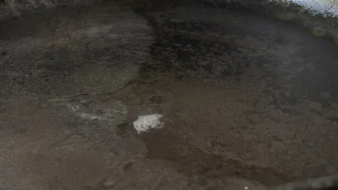 Water Drop Hits Hot Frying Pan Creating Sharp Sizzling Sound Stock Footage 328916662