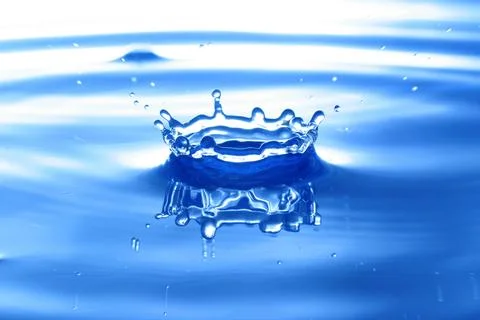 Water drop hits surface Stock Photos