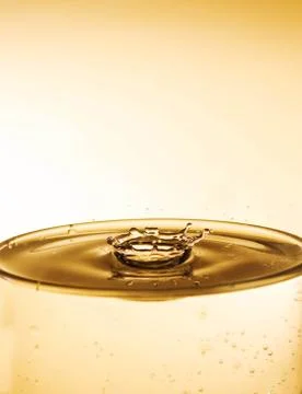 Water drop impact on water surface Stock Photos