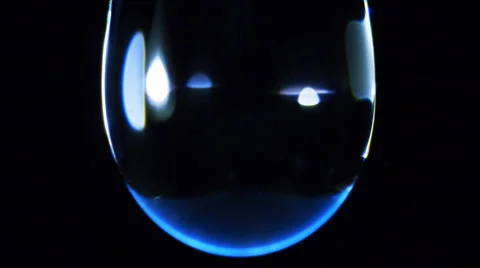 Water drop macro. The surface shimmers in different colors Stock Footage 45300258