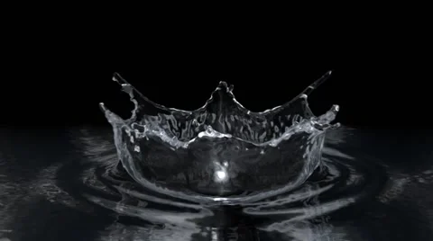 Water drop making splash on black background in slow motion. Stock Footage 52247470