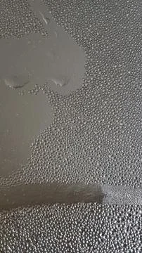 Water drop pattern on glossy foil texture closeup Stock Photos