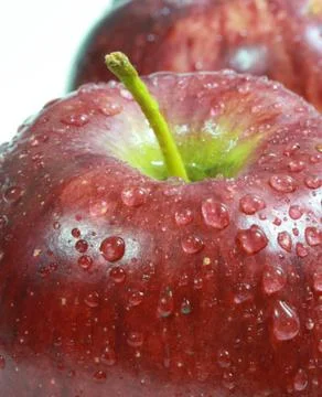 Water drop on red apple surface Stock Photos