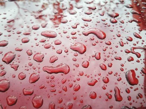 Water drop on red background Stock Photos