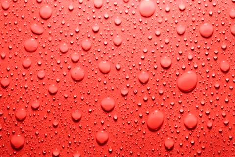 Water drop in red Stock Photos