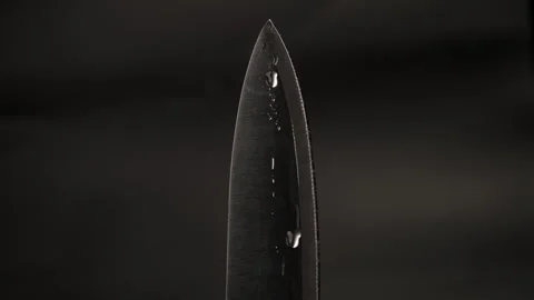 Water drop on sharp knife isolated on dark background. water splashing on knife. Stock-Footage 248301886