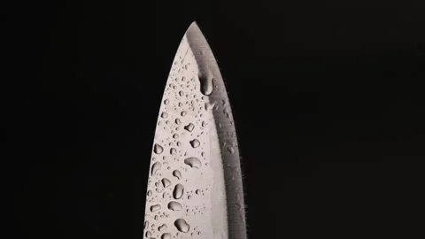 Water drop on sharp knife isolated on dark background. water splashing on knife. Stock-Footage 248301938