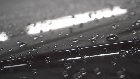 Water drop sliding down the car hood close up Video stock 155846279