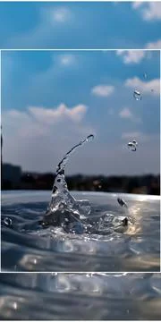 Water drop splash blue colored Water drop and ripples with blue Sky Stock-Fotos