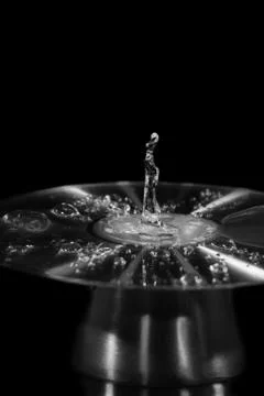 Water Drop Splashes To Create Shapes On A CD Stock Photos