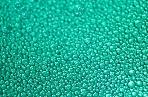 Water drop texture on turquoise background . Stock Photos