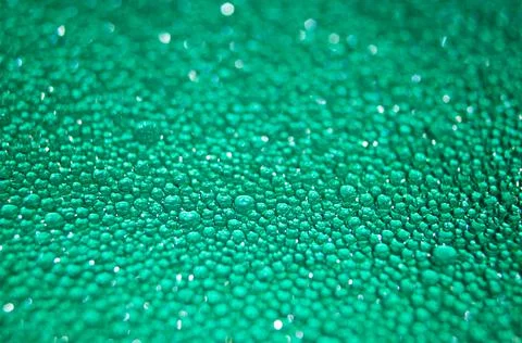 Water drop texture on turquoise background . Stock Photos