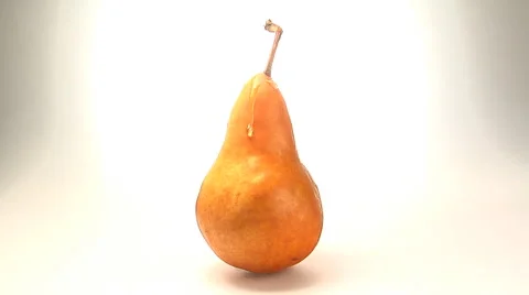 Water drop trickles down the side of an organic pear rotating Stock Footage 46585572