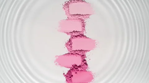Water droplet creating circles over pink powder Stock Footage 335433813