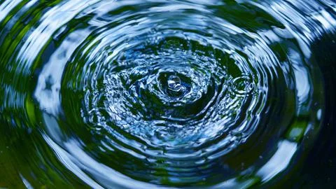 Water droplets affect the surface, forming rings on the surface. Stock Photos