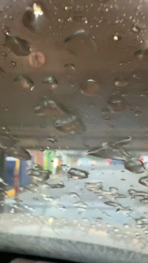Water Droplets Blown Across Windshield During Automatic Car Wash Close-Up Stock Footage 340680404