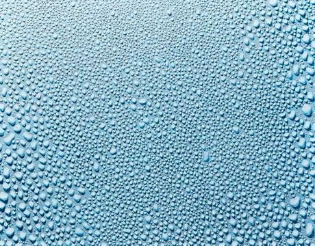 Water droplets on a blue surface Stock Photos