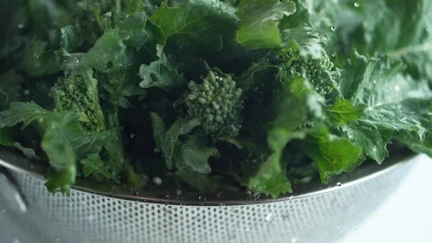 Water droplets on broccoli rape. Slow Motion. Stock Footage 87233843