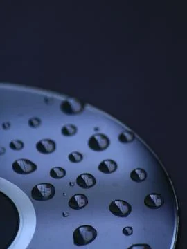 Water droplets on Compact disk. Blue background. Abstract concept Foto stock