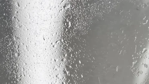 Water droplets condensing on a steamy window with soft light, creating a ca.. Stock Footage 335139423