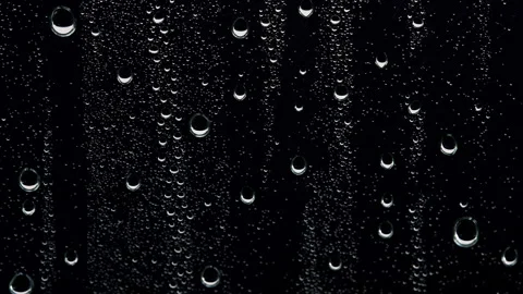 Water Droplets Dripping Down Dark Glass Surface Close Up Stock Footage 346080529