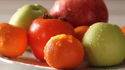 Water droplets dripping down a variety of fruits Stock Footage 144358464