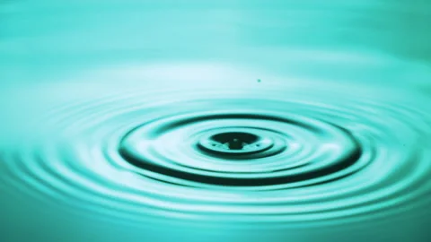 Water Droplets Fall Down on the Water Surface. Dripping Water Drops Creating Stock-Footage 254466457