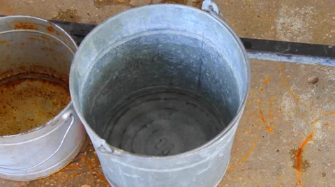 Water droplets falling in the bucket Stock Footage 38284116