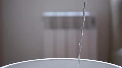 Water Droplets Falling into a Bucket Stock Footage 317562239