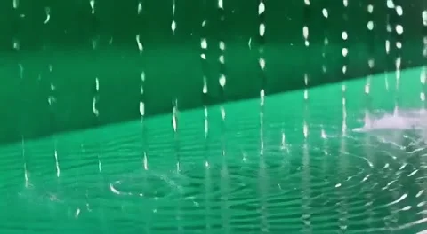 Water droplets falling into a pool of wa... | Stock Video | Pond5