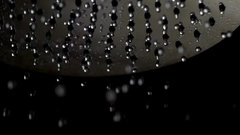 Water droplets falling from a shower head against black Video stock 332283627