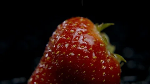 Water droplets falling onto a strawberry Stock Footage 128720236