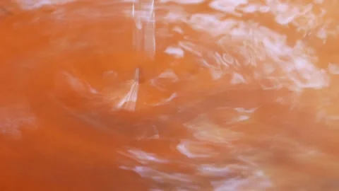Water droplets falling in the water Stock Footage 304773457