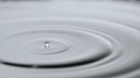 Water droplets floating on water surface - delayed droplet coalescence Stock Footage 143060927