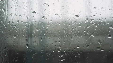 Water droplets flowing down on clear glass background raindrops rainstorm Stock Footage 186955405