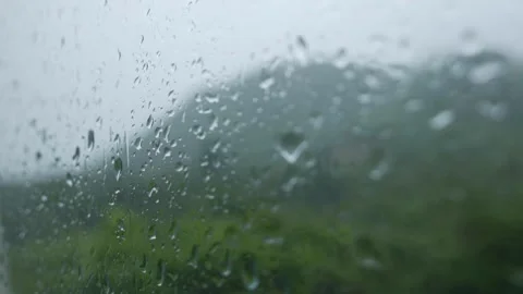 Water droplets form patterns on window surface as rain gently falls outside Stock-Footage 322166540
