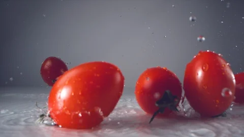 Water droplets on fresh cherry tomatoes. Slow Motion. Stock Footage 128772276